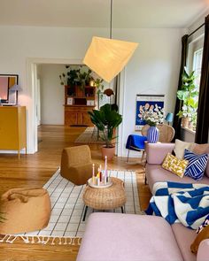 a living room filled with lots of furniture and decor