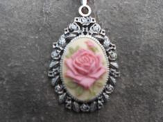 For sale are beautiful flawless (pink rose with a single bud, with green leaves on a tan beige background) cameo pendant necklaces!!!! They are offered at a reasonable price, make perfect gifts, and are wonderful quality!!!!  The cameo is set in an ornate tibetan silver setting, and the chain is 22" .925 silver plated 1.2mm snake chain, with a lobster claw clasp!!!!  I make several varieties, colors, styles and matching sets!!!!  I will be glad to do special requests or matching pendant, cuff br Cameo Pendant Necklace, Cameo Pendant, Beige Background, Snake Chain, Lobster Claw, Pink Rose, Matching Sets, Green Leaves, Pendant Necklaces