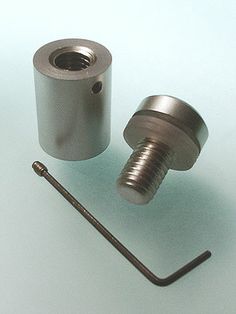 an image of two metal parts on a white surface with a screw and thread in the middle