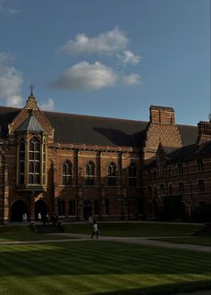 people are walking around in front of a large building