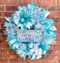 a wreath that says fresh flurries hanging on a brick wall