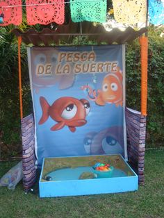 an outdoor play area for children with fish and bubbles on the water in front of it