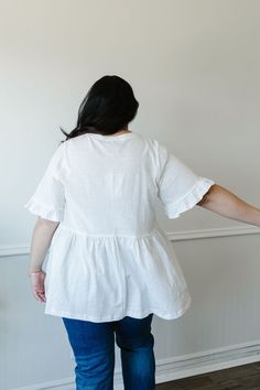 ALL SALES FINAL NOT ELIGIBLE FOR RETURN The Addie Peplum is the perfect addition to your wardrobe. With its classic white color and flattering peplum style, this top will elevate any outfit. The ruffled short sleeves and split side hems add a unique touch to this versatile piece. A must-have for a stylish and effortless look. This shirt is see through, we suggest one of our layering tanks or half tees. Fits true to size. Model is wearing a small and is 5'7". Plus model is wearing a 1X and is 5'5 White Cotton Tops With Ruffle Hem, White Feminine Cotton Peplum Top, Ruffle Hem Peplum Top For Brunch, White Fitted Cotton Peplum Top, White Spring Peplum Top, White Cotton Peplum Top With Ruffles, White Peplum Top For Spring, White Feminine Top With Ruffle Hem, White Cotton Peplum Top