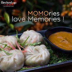 some dumplings are sitting on a plate with dipping sauce