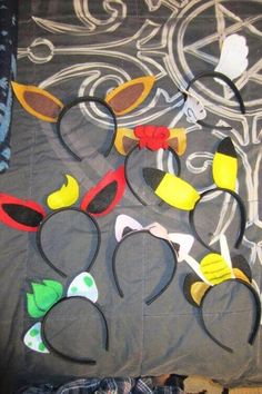 several mickey mouse ears are laid out on a bed