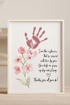 a hand print with the words i'm like mother, and pink flowers on it