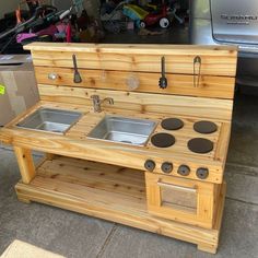 an old fashioned wooden stove with two sinks