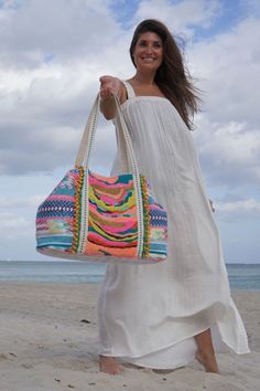 Handwoven Jacquard Beaded boho bag Vibrant hues of yellow, pink, green, and gold Stunning hand-embellished embroidery and beadwork Mini Pompom detailing Shoulder straps with lace detail Size: 23" X "13" X 6" Our Daphne Embellished Tote is literally stunning. With a breathtaking amount of hand beading and embroidery in shades of yellow, pink, green, and gold, this bag will be the bag everyone is talking about. Mini pom pom detailing and handwoven jacquard are additional features of this truly one Patchwork Quilting Designs, Mini Pom, Crochet Hoodie, Embellished Bags, Rainbow Crochet, Shades Of Teal, Crochet Bags Purses, Boho Bags, Boho Bag