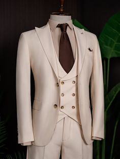 Color: beige Material: 73% polyester, 23% viscose, 4% elastane Suit includes blazer, waistcoat, & trousers Single-breasted suit (2-button blazer) Lapel type: peak lapels Jacket interior lining option: fully-lined Jacket vent: double vent Fitting: modern-fit Care instructions: dry clean only Machine washable: no Beige Fitted Tuxedo Set, Fitted Double-breasted Three-piece Suit For Semi-formal, Beige Tuxedo Set With Notch Lapel, Tailored Beige Suits For Office, Beige Tuxedo Set For Business, Fitted Beige Single Breasted Sets, Beige Fitted Single Breasted Sets, Fitted Beige Single-breasted Sets, Beige Fitted Single-breasted Sets