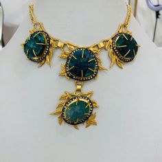 This necklace has beautiful green corundum stone on metal leafy twigs all studded in brass metal with 18K gold plating. It's a perfect go to necklace which can go well with any traditional or indo-western outfit and can enhance your look.This is all handmade necklace. Bohemian Gold Jewelry With Emeralds, Artisan Gold Necklace With Gemstone Accents, Gold Emerald Jewelry With Gemstone Accents, Festive Handmade Gold Emerald Necklace, Gold Necklaces With Gemstone Accents For Festive Occasions, Gold Emerald Jewelry With Natural Stones, Gold Emerald Pendant Necklace With Natural Stones, Gold Necklace With Gemstone Accents For Festive Occasions, Bohemian Gold Necklaces With Stone Setting