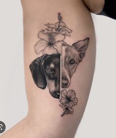 a woman's thigh with two dogs and flowers on it