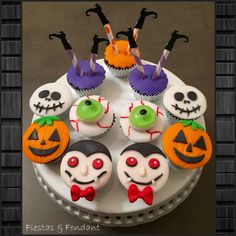 cupcakes decorated with halloween decorations on a plate