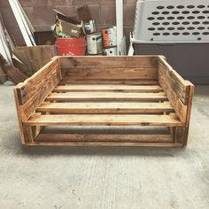 a wooden crate sitting on top of a cement floor