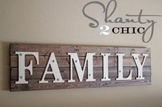 a family sign hanging on the wall above a bed