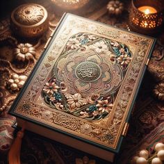 an ornate book with arabic writing on it surrounded by other decorative items and candles in the background