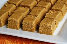 several squares of brown cake on a white plate