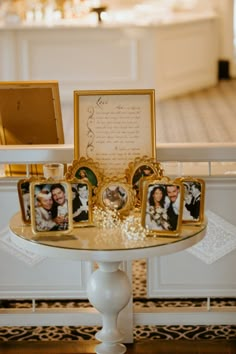 a table topped with pictures and frames on top of it