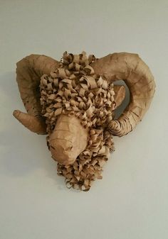 an animal made out of mushrooms on a white wall