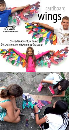 two children are making colorful wings out of paper and cardboards, while another child sits on the ground in front of them