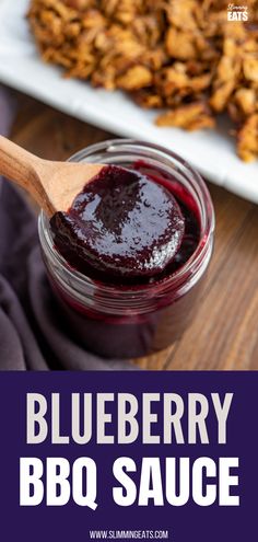 blueberry bbq sauce in a glass jar with a wooden spoon on the side