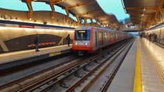 a red train is coming down the tracks in a station with people standing on either side