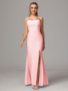 a woman in a long pink dress with a slit on the side and one leg