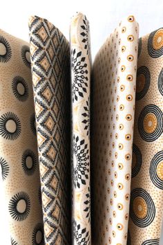 Five South African shweshwe fabrics in light beige with different black and light brown printed patterns on each fabric. Shweshwe Dresses South Africa, Beige Wedding Theme, Traditional Dresses African, Reception Decoration Ideas, Market Lights, Modern African Clothing, Wedding Decorations Ideas