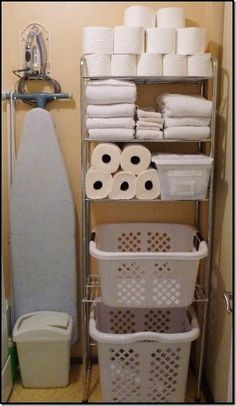 the bathroom is organized with toilet paper, towels and other things to keep dry in