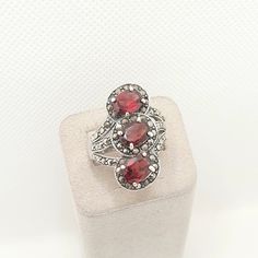 DESCRIPTION: A heavy and chunky solid sterling silver vintage ring, adorned with genuine garnets (100% tested) and marcasite gemstones. The ring is stamped "925", it sizes approx. at UK Q.5 or US 8.5 and weighs approx. 7.86g. Mountains of unique antique and vintage pieces in our shop!  **FREE worldwide shipping on all items. Fill your boots **Plenty of experience. Everything guaranteed and authentic **Returns accepted Check out our Instagram and website - @opulentantiques www.opulentantiquesstor Antique Silver Garnet Rings, Victorian Silver Ring With Garnet, Victorian Garnet Silver Ring, Victorian Style Garnet Silver Ring, Silver Three-stone Ruby Ring, Silver Ruby Ring With Three Stones In Oval Shape, Silver Ruby Ring With Three Stones, Formal Silver Ruby Ring With Three Stones, Formal Silver Ruby Three Stone Ring