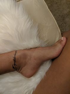 a woman's foot with a tattoo on it