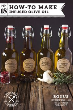 three bottles of olive oil on a wooden table with herbs and spices in front of them