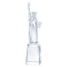 a crystal statue of the virgin mary holding a bird on her arm, standing upright in front of a white background