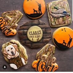 decorated cookies are arranged in the shape of dogs and hunting related items, with words that read clark's duck island