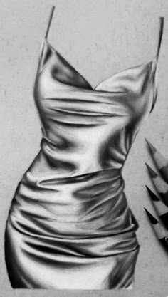 a pencil drawing of a dress on a table