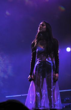 a woman standing on top of a stage