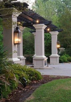 an outdoor patio with lights on the pillars