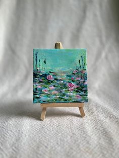 a small easel with a painting on it