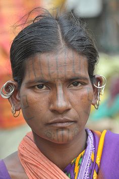 a woman with tattoos on her face and nose