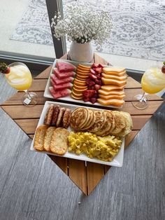 a table topped with plates of food and drinks