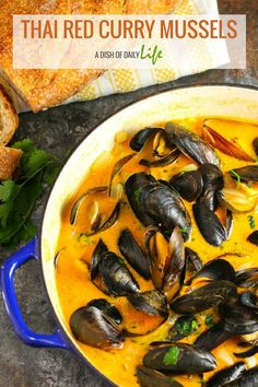 thai curry mussels in a blue pot with bread on the side