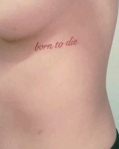 a woman's stomach with the words born to die written on it, in cursive font