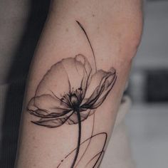 a black and white photo of a flower on the right arm, with lines running through it