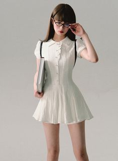 Channel a charming scholarly look with our Vintage Scholar Pleated Mini Dress. This delightful white dress combines classic elements with a modern mini length, perfect for a variety of occasions. Product Details: Color: White Style: Vintage-inspired mini dress Features: Pleated skirt, collar detail, short sleeves Available Sizes: XS, S, M Size Chart (measurements in cm): Size Length Bust Sleeve length Waist XS 73 84 15 64 S 73 88 15 68 M 75 92 16 72 Model Information: Height: 165cm Weight: 50kg Wearing Size: S Styling Tips: This versatile dress can be styled for both casual and semi-formal occasions. Pair with loafers and ankle socks for a true scholarly look, or dress it up with heels and delicate jewelry for a night out. Add a cardigan or blazer for cooler weather. The pleated skirt and Elegant White Mini Dress With Doll Collar, Chic Fitted Mini Dress With Doll Collar, Summer Mini Dress For The Office, Summer Mini Dress For Office, Elegant Fitted Mini Dress With Doll Collar, White Mini Dress For Office, Preppy Fitted Knee-length Dresses, Feminine White Pleated Mini Dress, Elegant Mini Dress With Doll Collar For Spring