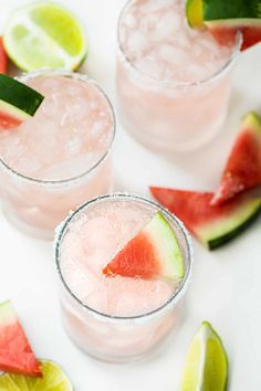 three glasses filled with watermelon and limeade on top of a white table