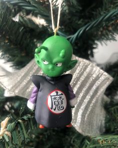 an ornament hanging from a christmas tree with chinese characters on it's back