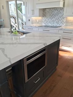 a kitchen island with an oven built into it