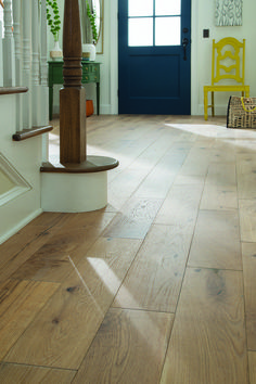 a wooden floor in front of a blue door