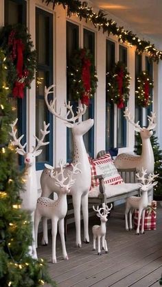 christmas decorations on the porch with deer and snowmen