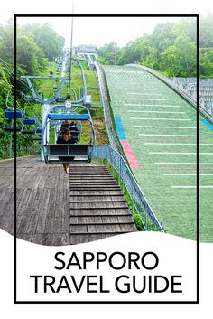 a person riding a ski lift on top of a wooden platform next to a lush green field