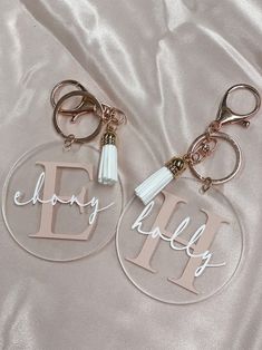 two personalized acrylic key chains with tassels